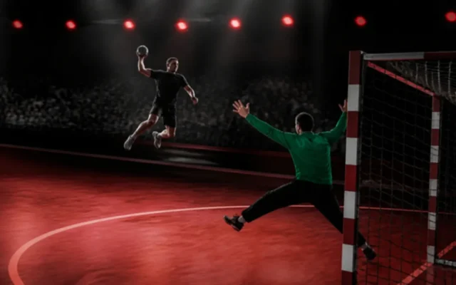 Handball Regeln: Spieler im Sprungwurf vor dem Kreis, Torwart wehrt ab