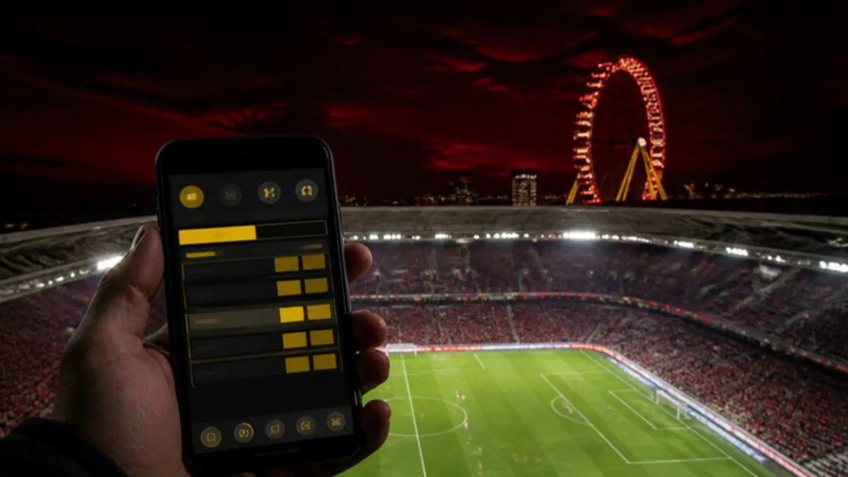 Interwetten Sportwetten: Wett-App im Stadion mit dem Wiener Riesenrad im Hintergrund